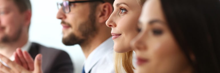 Group of colleagues listening to a speaker