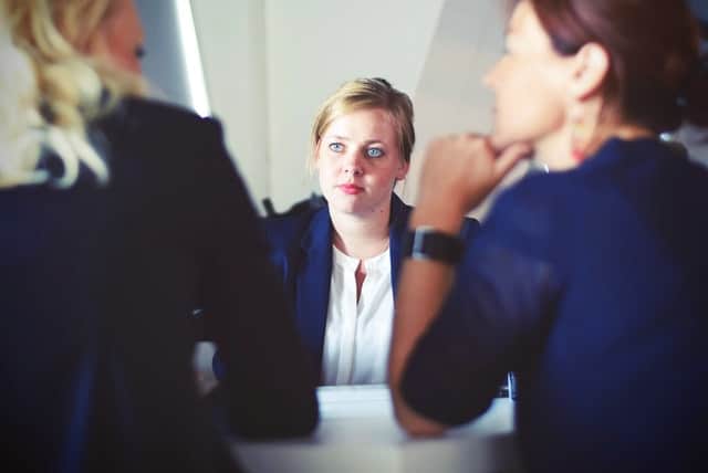 Woman at desk looking like she has made a mistake