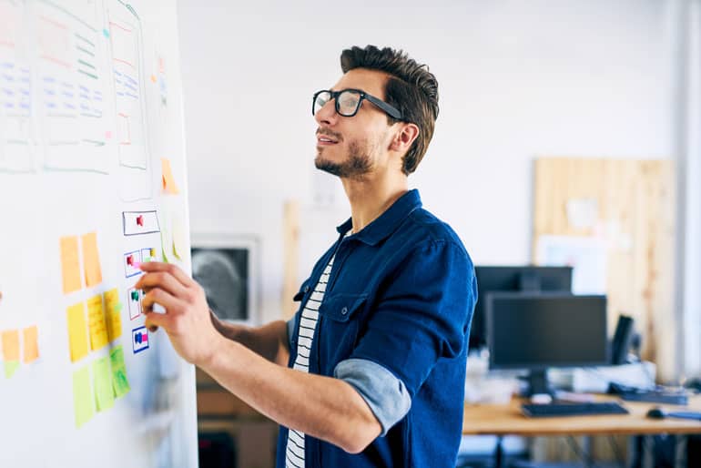 Man using agile approaches on white board