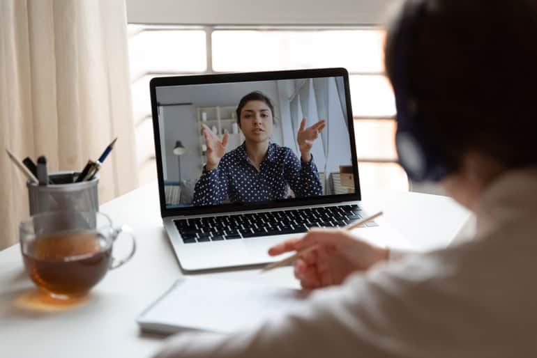 Woman in computer meeting asking why