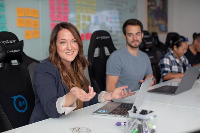 Young business colleagues in conversation at their desk