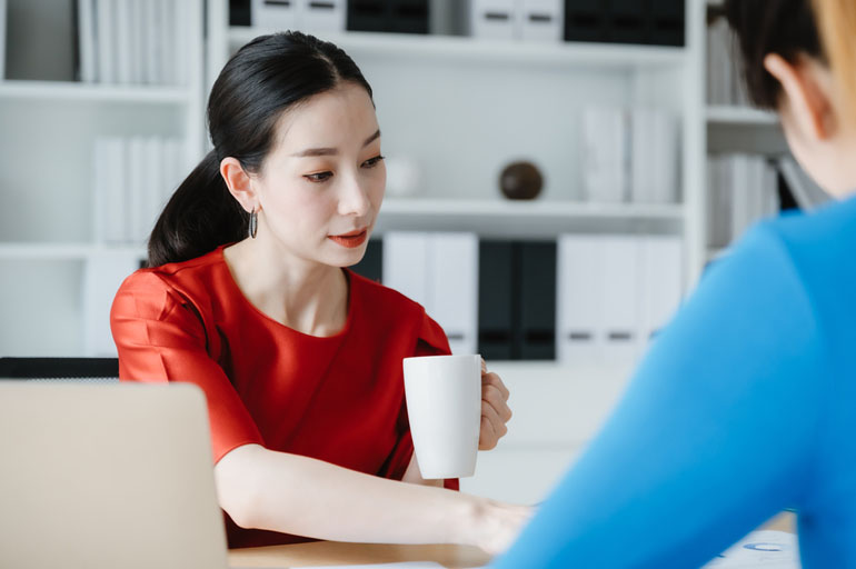 Woman at computer reviewing project management compliance