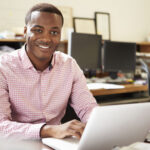 Male professional reviewing the CAPM exam format and content from his laptop.